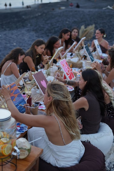 A group of people painting on easels by the sea. 3