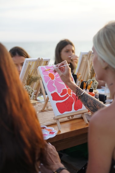 A person painting on a canvas with vibrant colors. 1
