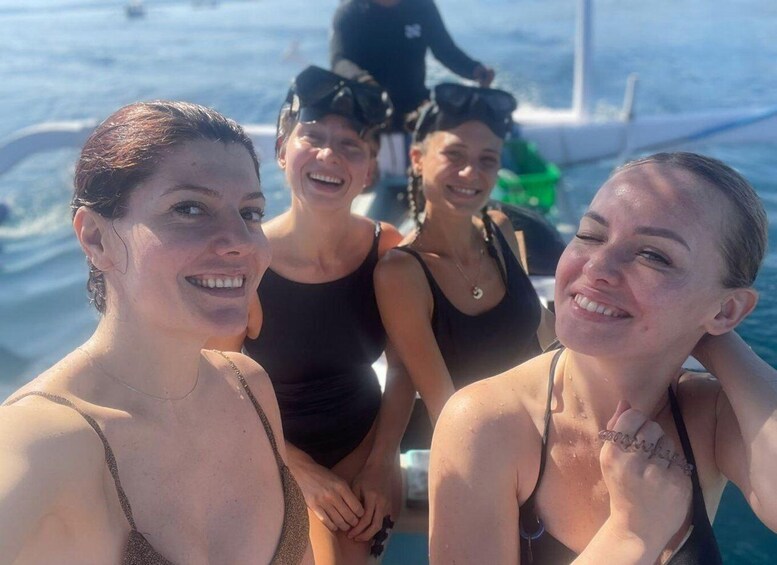 A group of people on a boat with the ocean in the background. 5