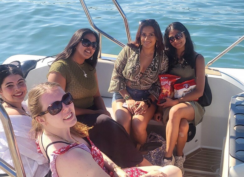A group of people on a boat with water in the background. 2