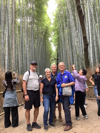 A group of people standing in a bamboo forest. 2