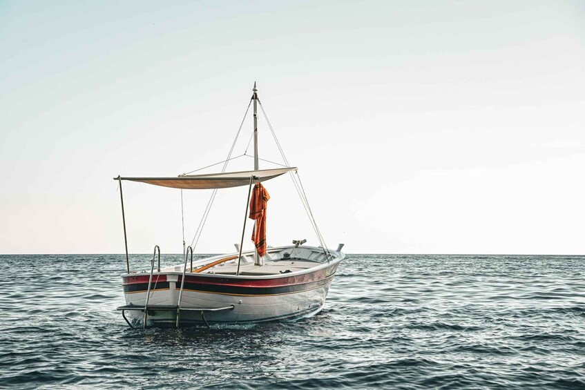 A small sailboat on calm water. 1