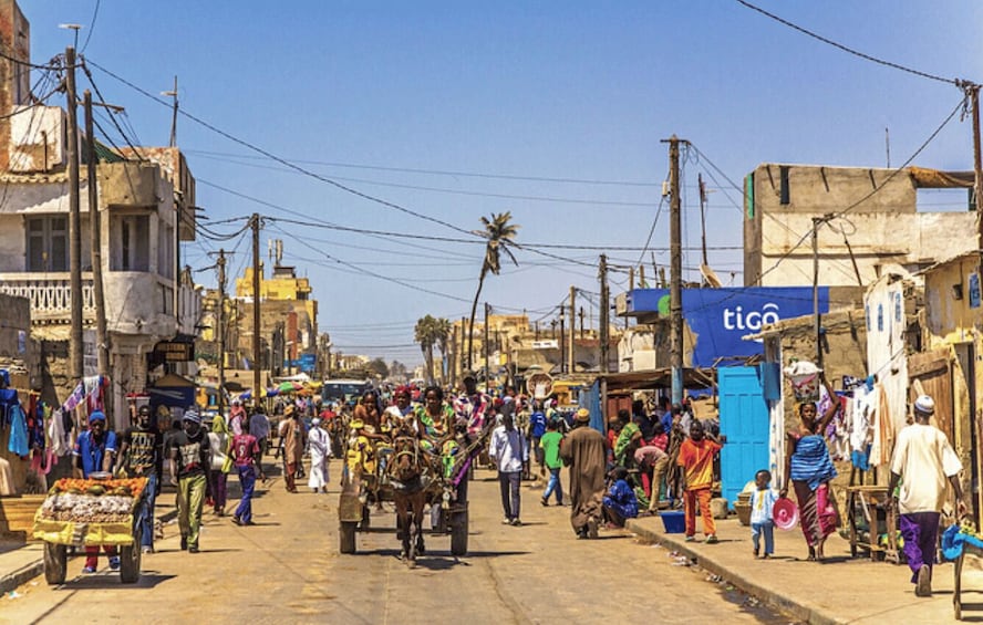 A bustling street market with vendors and shoppers. 3