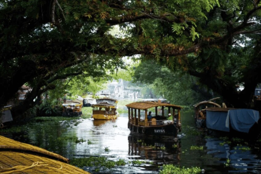 A river with boats and a canopy. 1