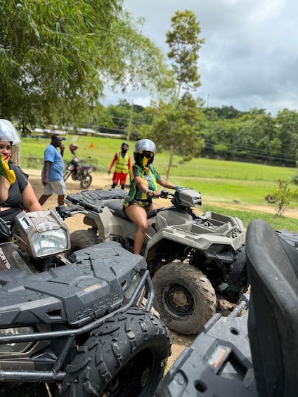 A group of people on ATVs in a rural setting with greenery and trees in the background. 5