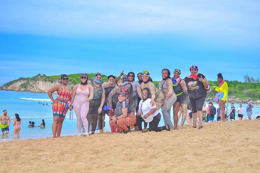 A group of people on a beach with the ocean and hills in the background. 3