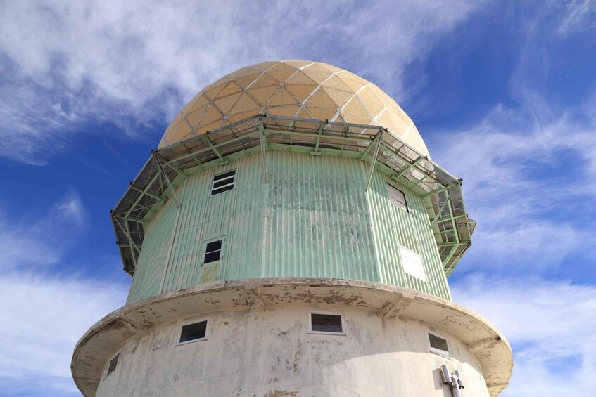 A weather station with a dome and a cylindrical base. 3