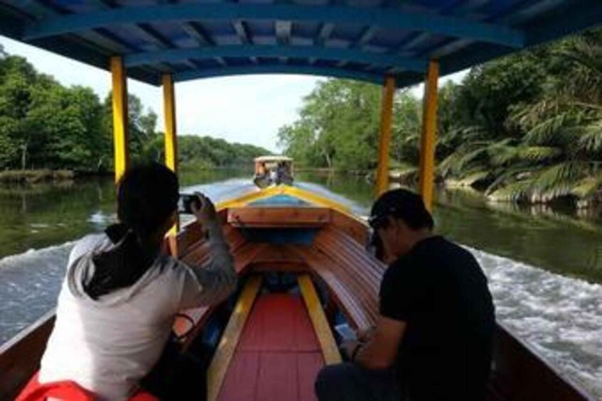 A narrow waterway with a boat carrying passengers. 3