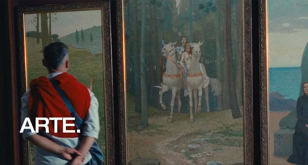 A person observing a painting with a landscape and figures on horses. 1