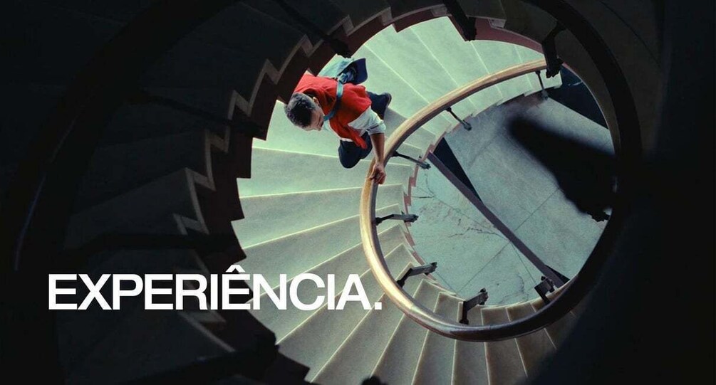 A person descending a spiral staircase. 3