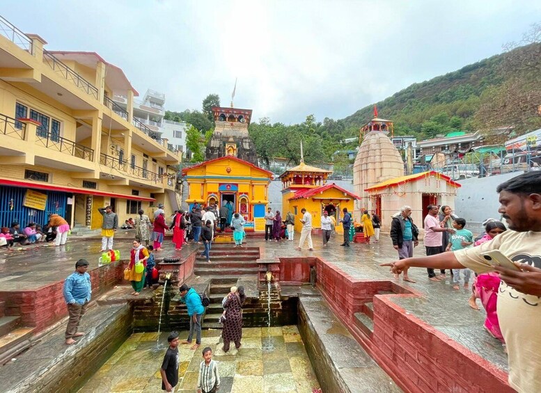 A temple complex with multiple structures, including a central building with a red roof and smaller surrounding buildings. 4