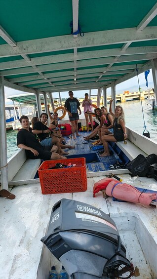 A group of people on a boat with a Yamaha Enduro jet ski on deck. 4