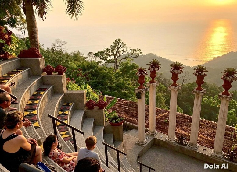 A staircase with people sitting, overlooking a coastal landscape with mountains and the ocean at sunset. 1