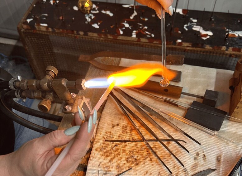 A person welding metal rods with a torch. 5
