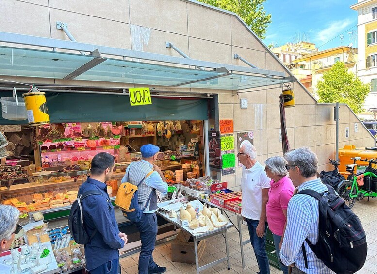 A street market with various food items and a sign indicating 'OOAH.' 4