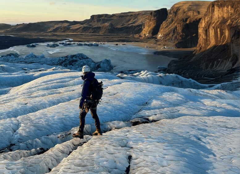 A person ice skating on a glacier with a mountainous landscape in the background. 3