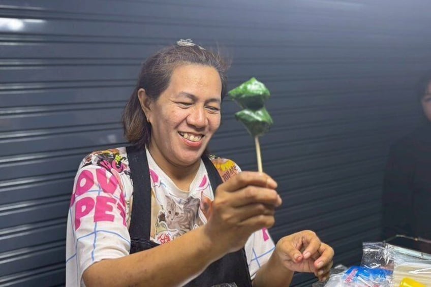 A person holding a green lollipop. 3