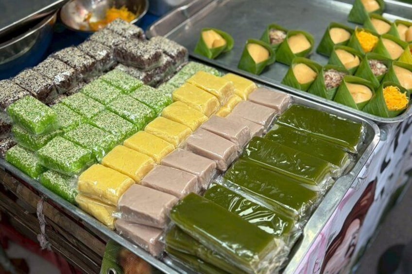A variety of colorful desserts displayed in trays. 1