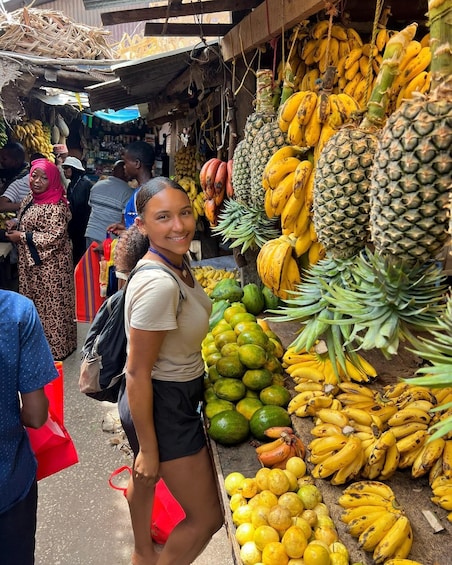 A market stall with various fruits like bananas, pineapples, and melons. 5
