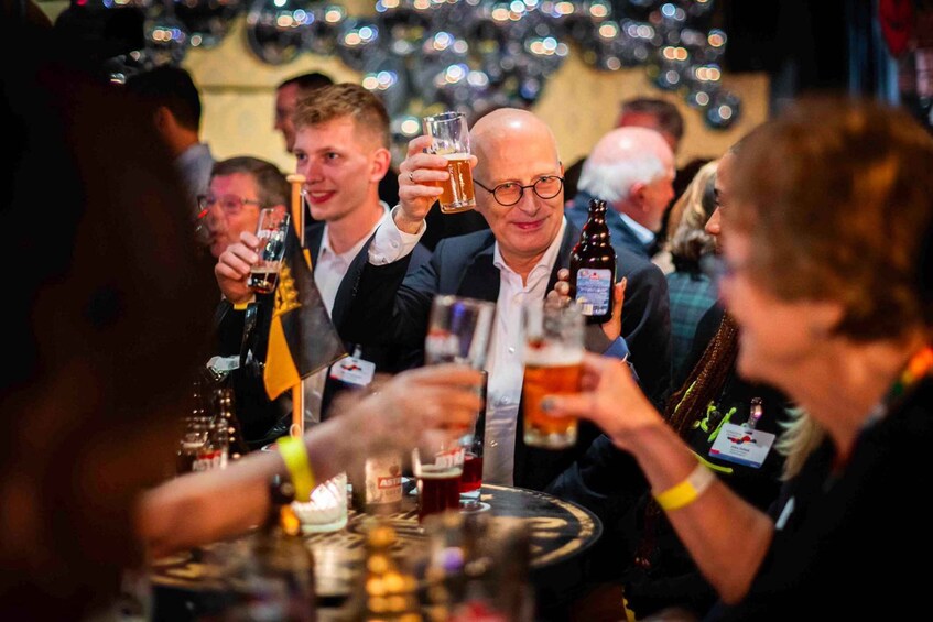 People toasting with beer glasses at a social gathering. 5