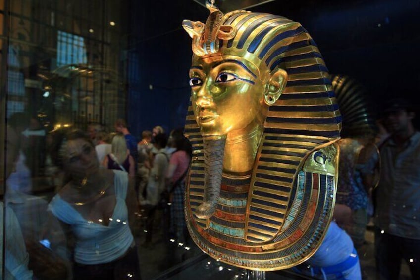 A golden Egyptian sarcophagus with hieroglyphics. 1