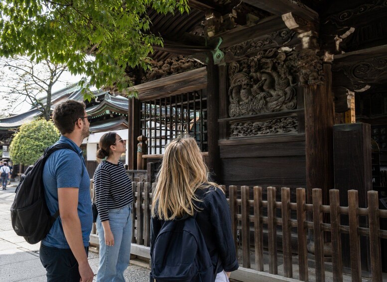A traditional Japanese building with intricate carvings and a wooden fence. 5