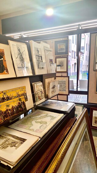 A gallery with framed artworks and maps. 5