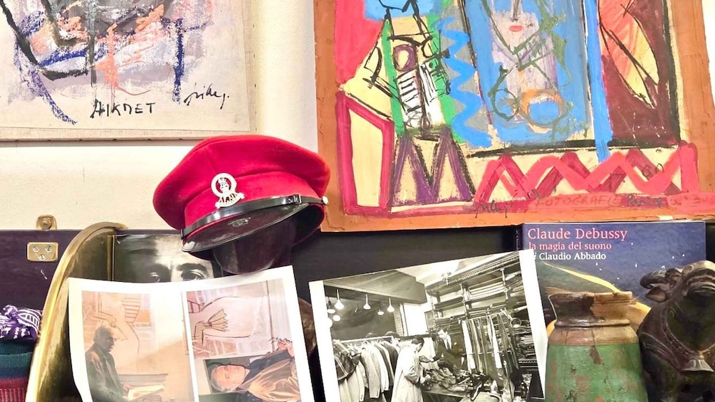 A collection of artworks, a red beret, and a book titled 'Claude Debussy.' 1