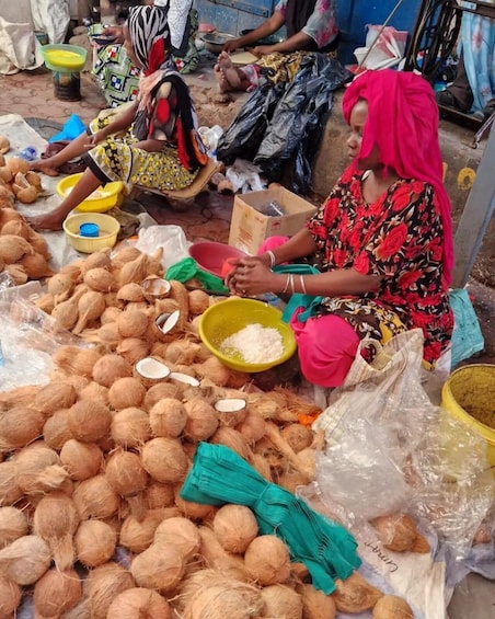 Women sorting coconuts at a market. 1