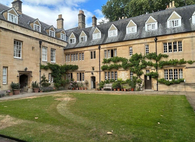 A historic building with a courtyard, stone walls, and ivy-covered windows. 3