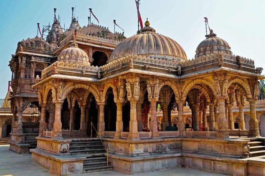 A historic temple with intricate carvings, domed roofs, and multiple arches. 4