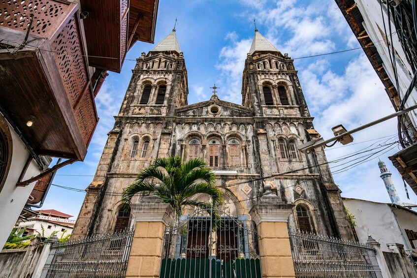 A historic cathedral with two bell towers, a central dome, and a surrounding fence. 4
