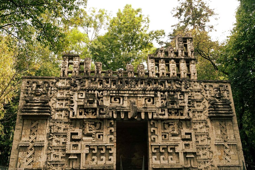 A stone temple with intricate carvings and a central doorway. 5