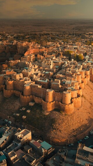 An aerial view of a historic walled city with dense architecture and fortifications. 2