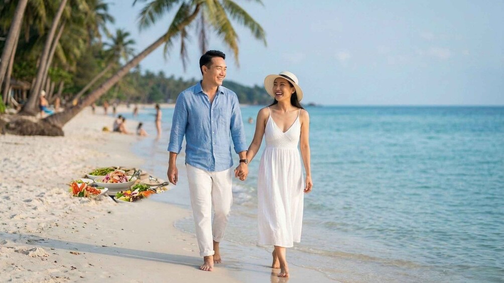 A couple walking on a beach with palm trees and a clear sky. 2