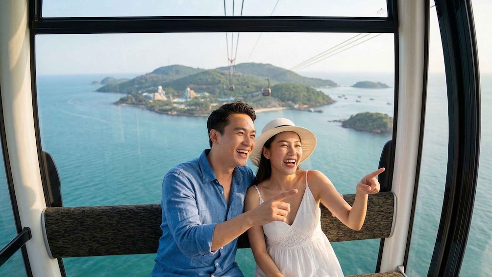 A couple on a cable car overlooking a coastal landscape with hills and a small island. 1