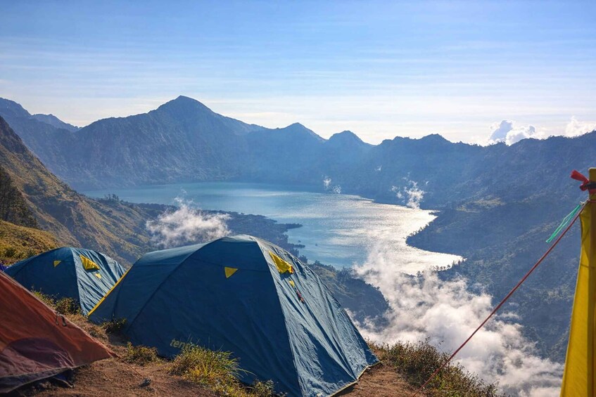 Tents on a mountain overlooking a lake. 4