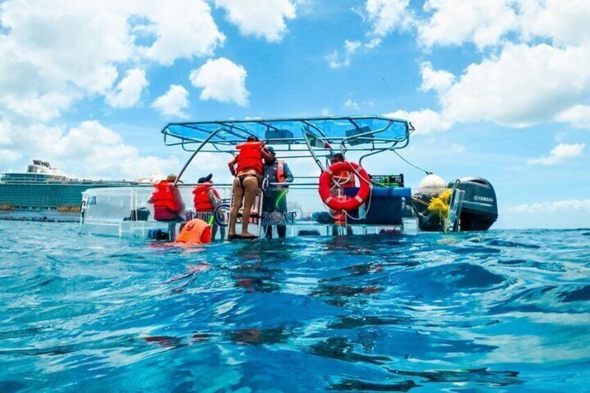 A boat with people wearing life jackets, a lifebuoy, and a large ship in the background. 5