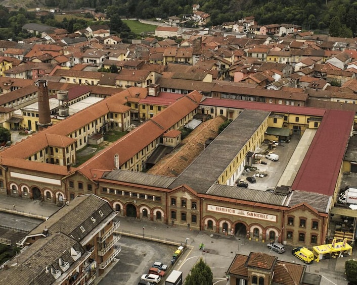 An aerial view of a town with historic buildings, including a prominent structure labeled 'BIRRIFICIO SAN MICHELE.' 3