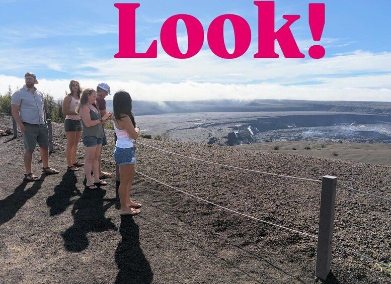 A group of people standing on a rocky outcrop overlooking a vast landscape with a clear sky. 4
