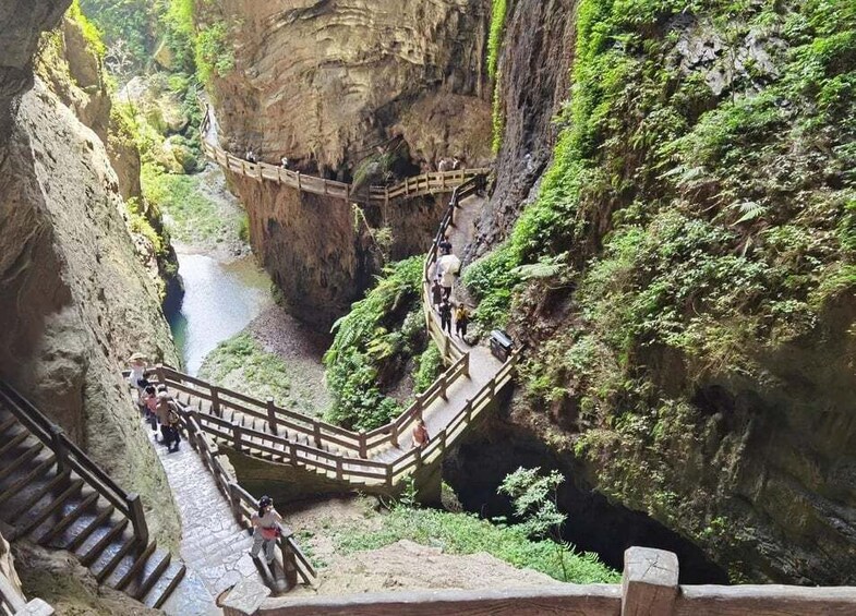 A narrow canyon with a wooden walkway and steps. 4
