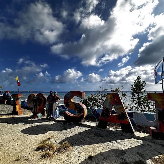 A beach with large letters spelling 'ISLAND' and a flag. 5