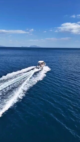 A speedboat moving across a calm sea with a clear sky. 3