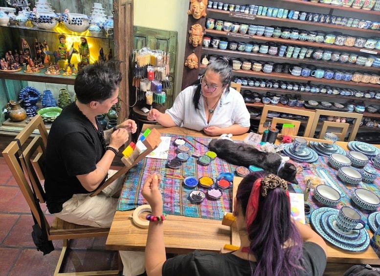 A pottery workshop with individuals engaged in ceramic crafting. 5