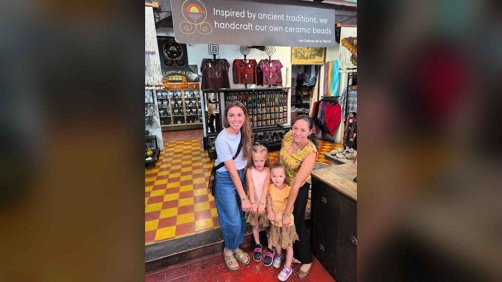 A family in a store with a sign about handcrafted beads. 4