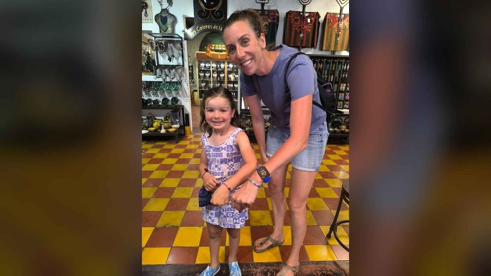 A person and a child in a jewelry store with checkered flooring. 2
