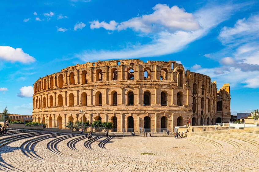 An ancient amphitheater with multiple arches and a circular layout. 1