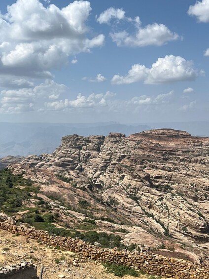 A rugged mountainous landscape with rocky formations and sparse vegetation. 2