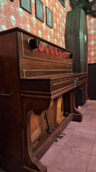 A vintage wooden stove with red knobs and a decorative front panel. 5