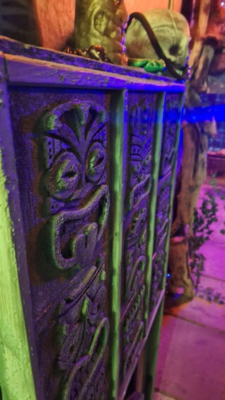 A decorative metal structure with intricate carvings and a greenish hue, possibly part of a building's architecture. 5